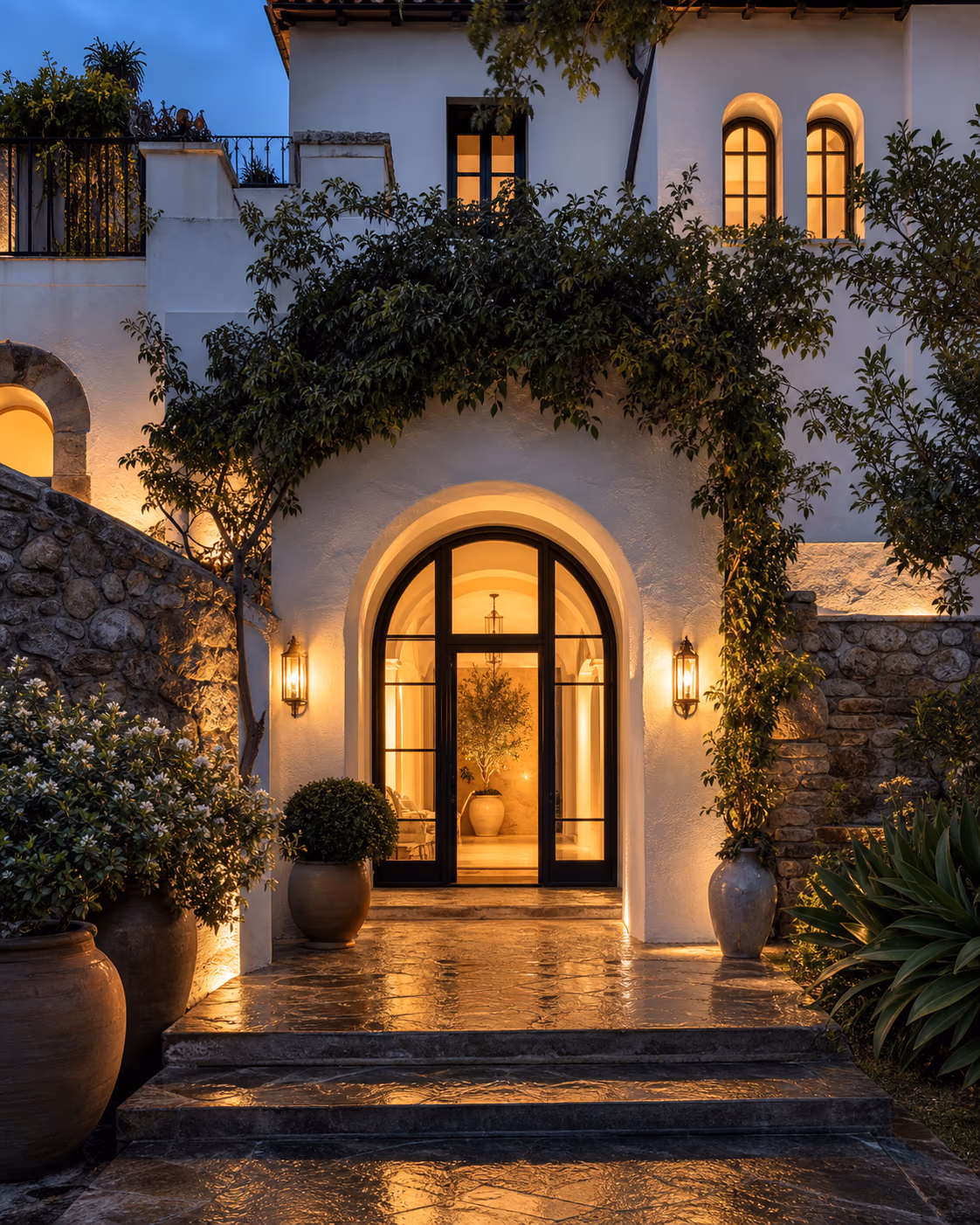 The arched entrance to Villa Dea, lit warmly at dusk